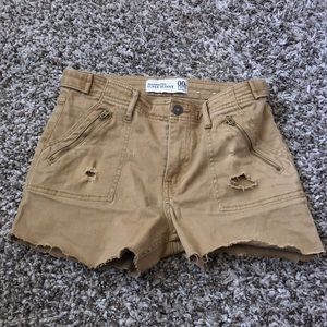 beige shorts with zippers in the side